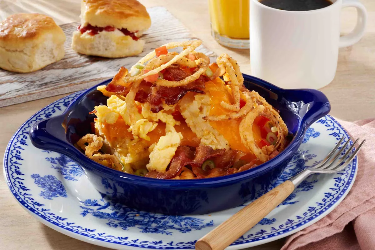 Cracker Barrel's Bacon n’ Egg Hashbrown Casserole with crispy bacon, scrambled eggs, and creamy hashbrowns.