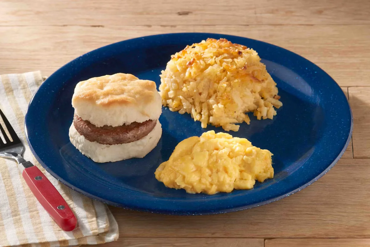 Cracker Barrel's Biscuit Breakfast Sandwich with fluffy scrambled eggs, bacon or sausage, and cheese on a buttery biscuit.