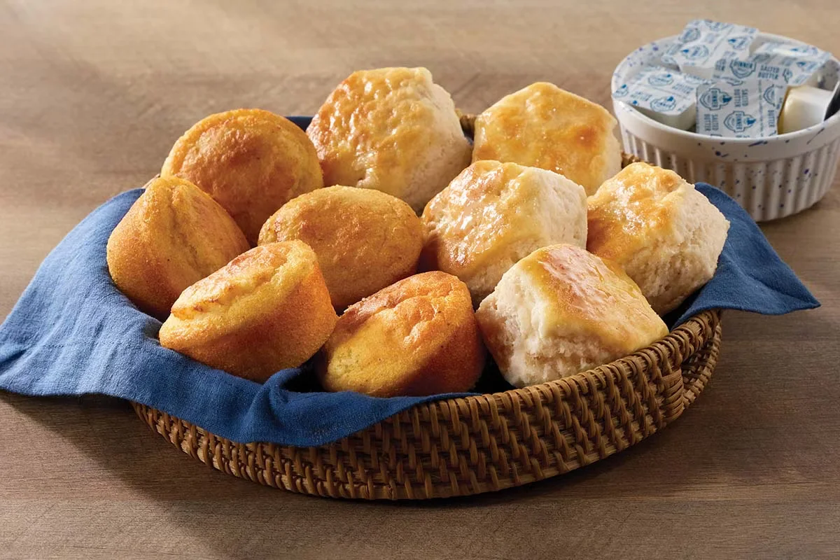 Cracker Barrel's Buttermilk Biscuits and Corn Muffins served warm, freshly baked, and golden brown.