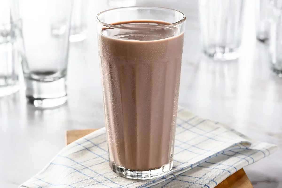 Cracker Barrel's Chocolate Milk, a creamy and sweet chocolate-flavored drink served cold in a classic glass.
