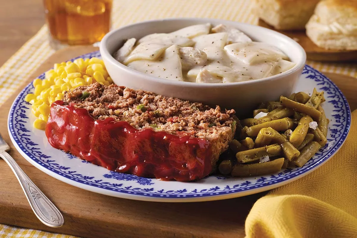 Cracker Barrel's Classics Sampler with meatloaf, chicken n’ dumplins, sugar-cured ham, and homestyle sides.