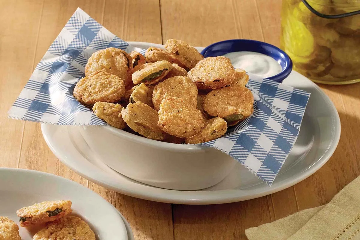 Cracker Barrel's Country Fried Pickles, crispy and golden-brown pickle slices served with a tangy ranch dipping sauce.