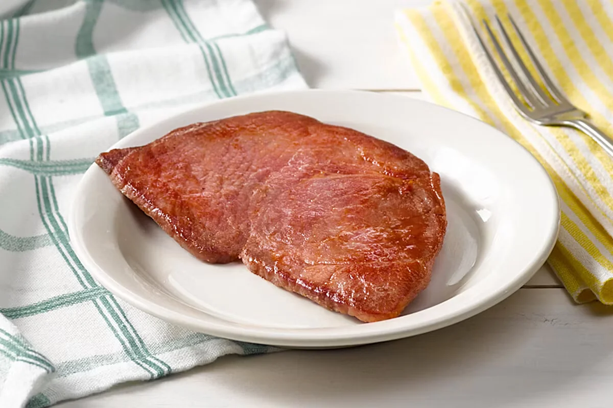 Cracker Barrel's Country Ham, thick-sliced and perfectly cured, served as a classic breakfast side.
