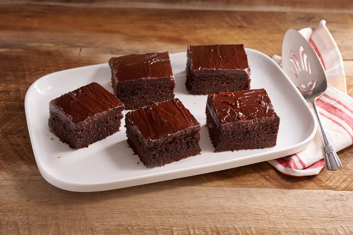 Cracker Barrel's Double Chocolate Fudge Coca-Cola® Cake topped with rich chocolate icing and served with a scoop of vanilla ice cream.