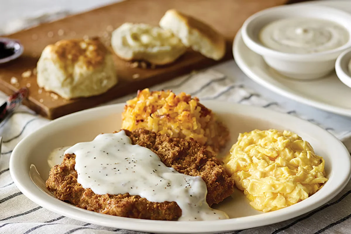 Cracker Barrel's Grandpa's Country Fried Breakfast with country fried steak, eggs, hashbrowns, and biscuits.