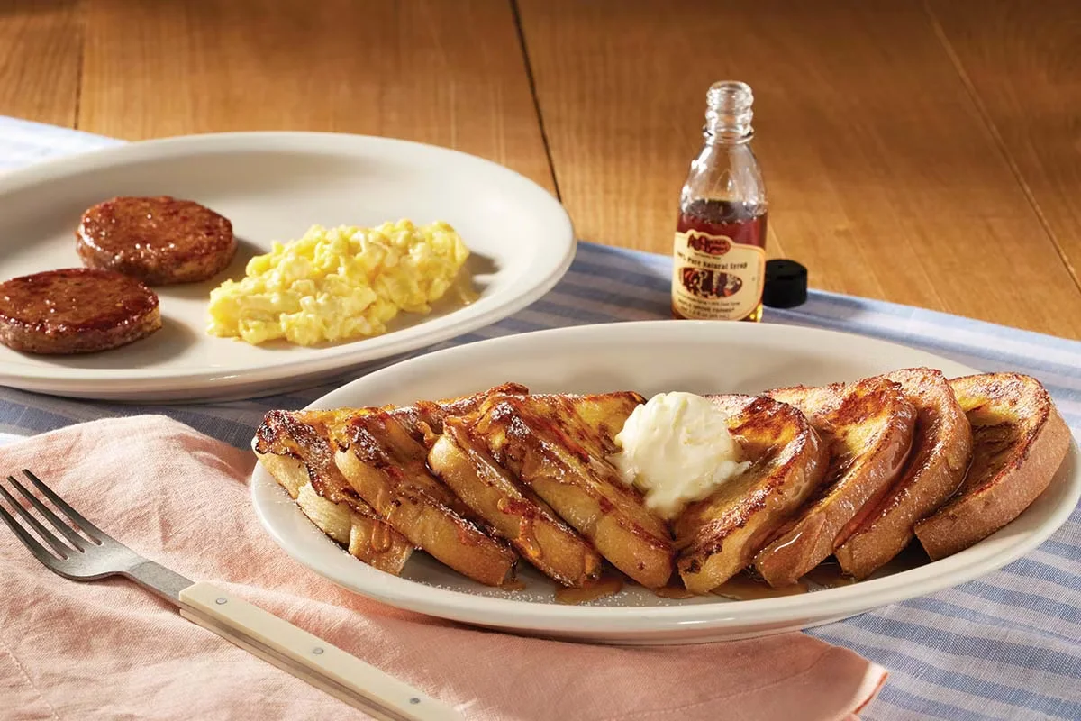 Cracker Barrel's Momma's French Toast Breakfast® with golden French toast, eggs, and bacon or sausage.
