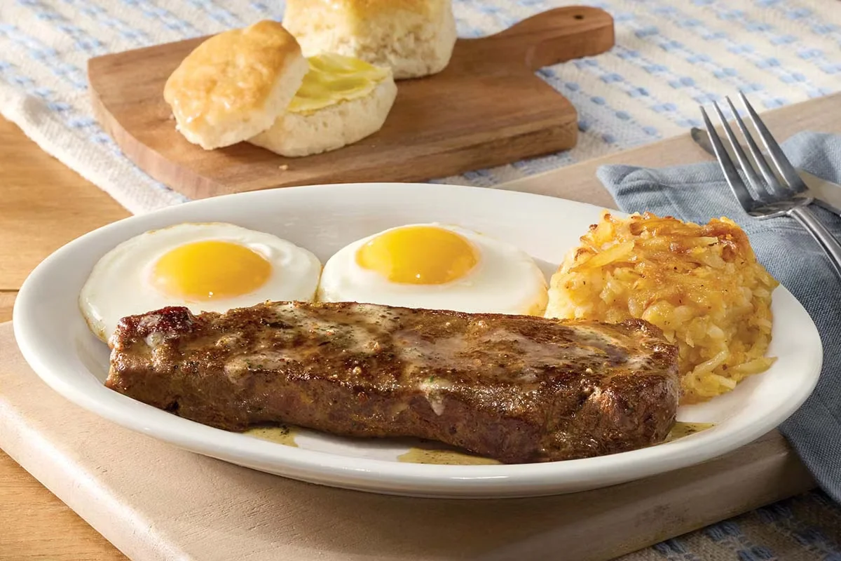 Cracker Barrel's New York Strip Steak n' Eggs with a juicy steak, scrambled eggs, hashbrowns, and biscuits.