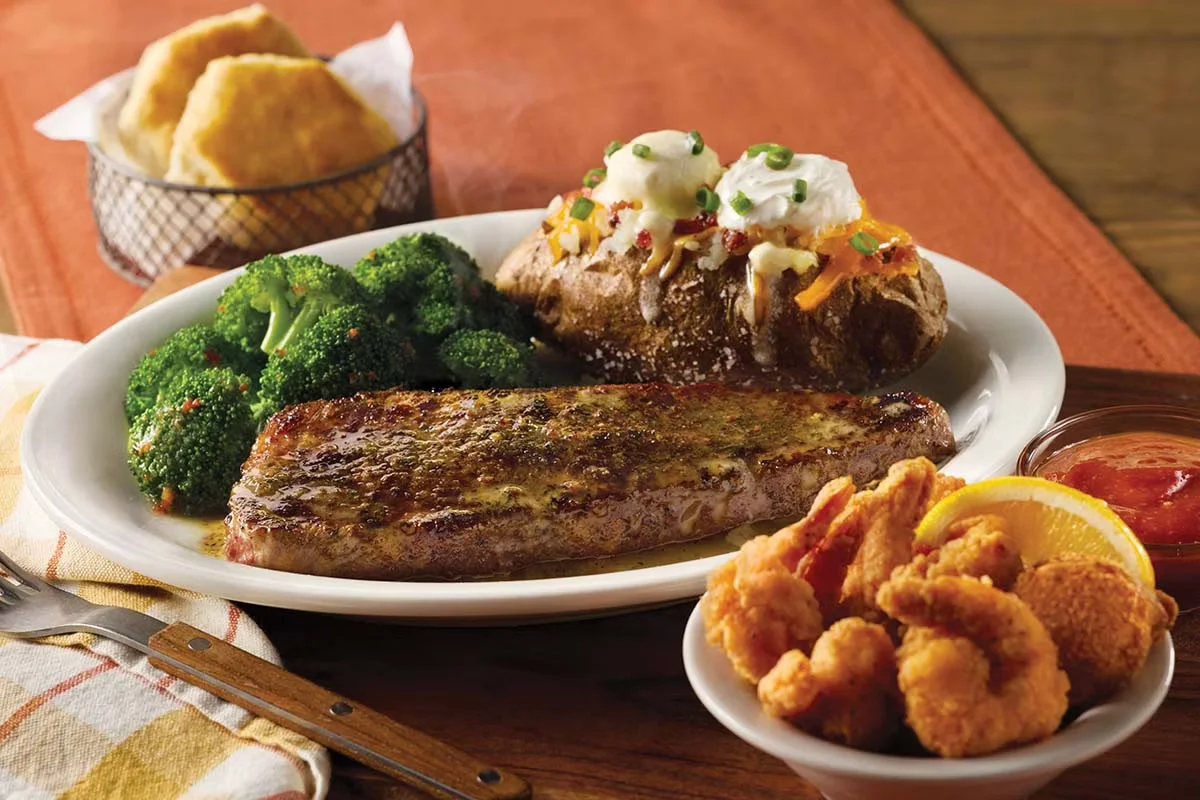 Cracker Barrel's New York Strip Steak n' Shrimp Combo, featuring a juicy steak and golden-fried shrimp served with homestyle sides.