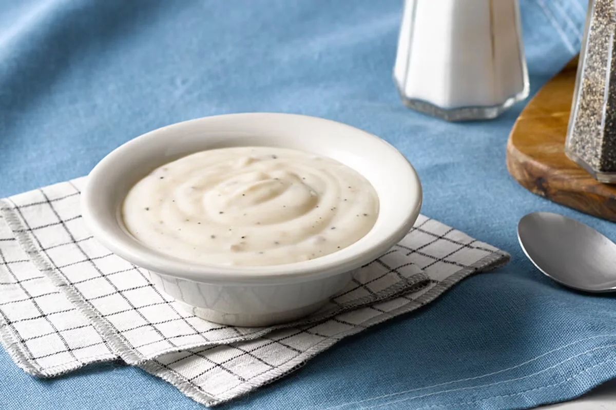 Cracker Barrel's creamy Sawmill Gravy, a savory sausage gravy served as a classic homestyle side.