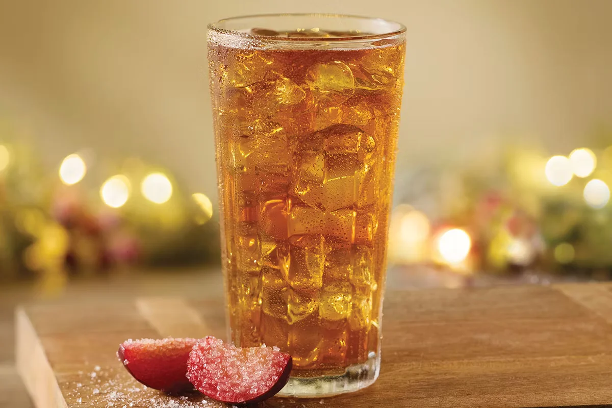Cracker Barrel's Sugar Plum Tea, a refreshing blend of sweet plum flavors and iced tea, served with ice.