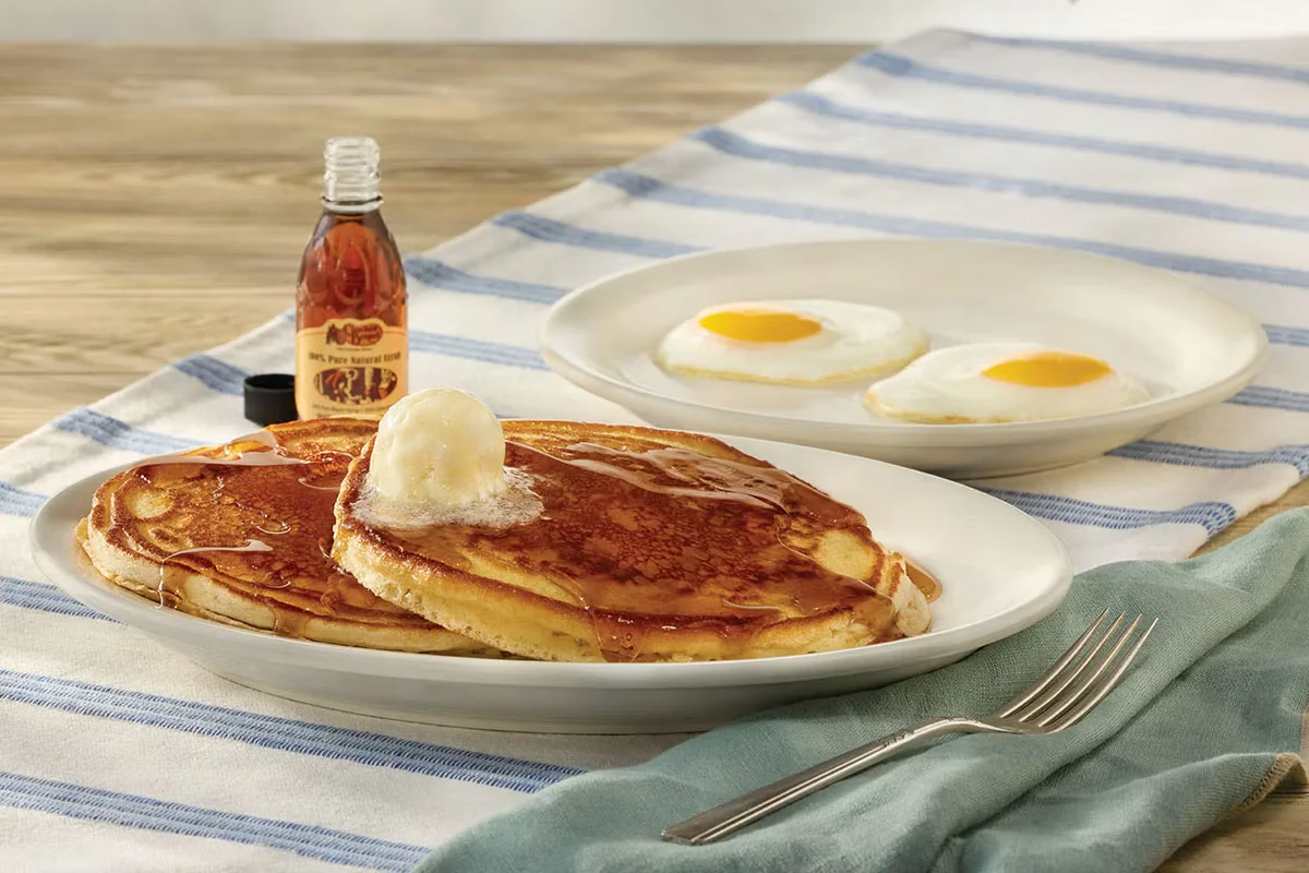 Cracker Barrel's Sunrise Pancake Special with fluffy pancakes, eggs, bacon, and syrup.