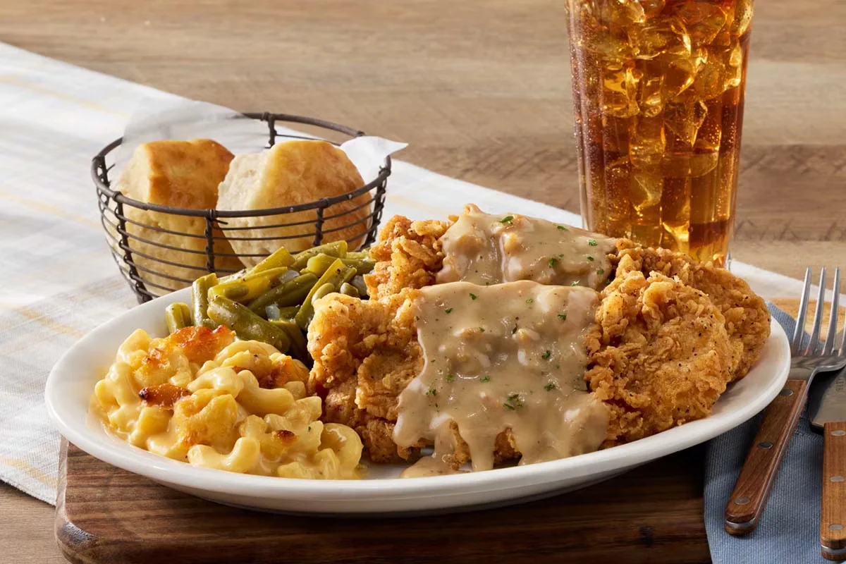 Cracker Barrel's Tuesday Country Fried Pork Chops, golden-fried pork chops served with creamy sawmill gravy and sides.
