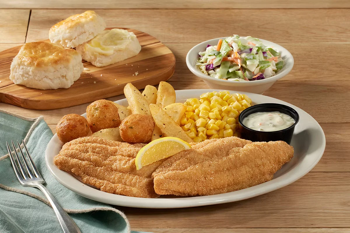 Cracker Barrel's U.S. Farm-Raised Fried Catfish, two golden-fried catfish fillets served with tartar sauce and homestyle sides.